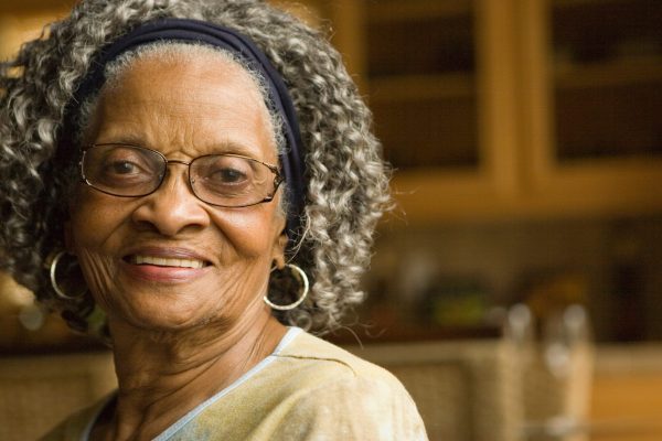 Happy elderly African American woman at her house.